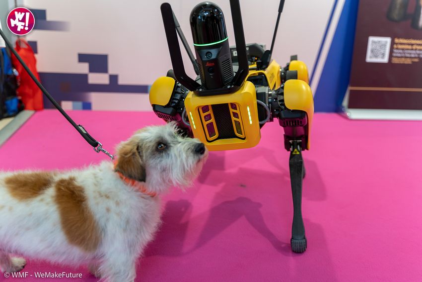 SPOT interacts with a dog in the expo area of WMF 2022
