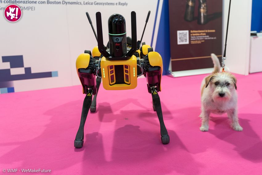 SPOT interacts with a dog in the expo area of WMF 2022